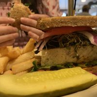 Tofu Today Sandwich. Fresh micro greens, portobello mushroom, salsa, tomato, and onion on top of baked tofu. Served with fries and a pickle  at Main Street Bistro in New Paltz