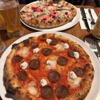 Salami pizza (seasonal christmas pizza in the background)  at FLIP - Vegan Pizza in Tampere