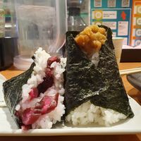 Half eaten pickle onigiri and 1 bursting with delicious ume. at Onigiri Gorichan Tenjin in Fukuoka