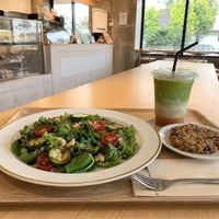 My vegan lunch at touch foods: Balsamic Tomato Salad (no cheese), organic Mango Matcha Latte with oat milk, and a gluten-free Superfood Cookie. Fresh, organic, and satisfying! at Touch Cafe in Tomigusuku