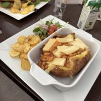 Baked potato with beans and vegan cheese   at Cafe Sorelle in Glasgow