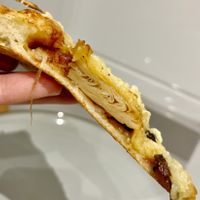 Slice of delivered Green BBQ vegan pizza with bbq sauce, plant based "meat", portobello mushrooms, fresh onion and grated vegan cheese at Papa John's  in Oviedo