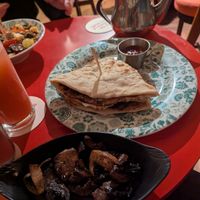 Sausage naan roll and side portion of mushrooms at Dishoom Permit Room in Cambridge