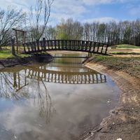 Bridge to the food forest and memorial at Sanctuary het Wijland in Darp