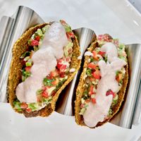 Tasty Tacos: We make our tacos out of butternut squash  and crack open a young coconut to make the sour cream.  at Conscious Kitchen Atx in West Lake Hills