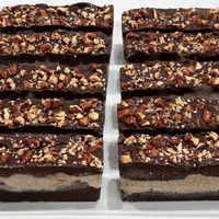 Decadent Desires: Our version of a Healthy Snickers Bar! All desserts are made with dates and maple syrup.  at Conscious Kitchen Atx in West Lake Hills