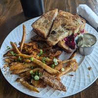Tempeh reuben with side fries and vegan aioli at Sneaky Pickle & Bar Brine in New Orleans