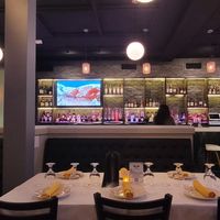 Full bar.  You can also see some of the paintings done by Buddhist monks and the TVs showing gorgeous scenes from Nepal. at Himalaya Sono in Norwalk