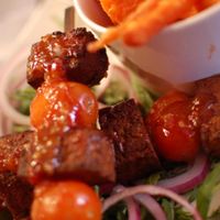 Tofu Thai Spiced Kebabs with Mango Dipping Sauce served with Red Onion, Spinach and Peashoot Salad with Sweet Potato Fries. at The Belgian Monk in Norwich