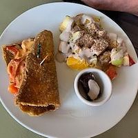 Lunch portion - cheesesteak and fresh fruit salad with out of this world drizzle. at Healthy Sins Vegan Cafe in Lockport