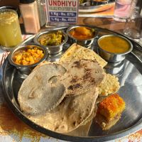 Vegan thali. There are three starters underneath the 3 different rotis.
Also missing is the dhal and rice that comes after the starter and mains as well as the deserts  at Chetana Veg. Restaurant & Bar (1946) in Mumbai