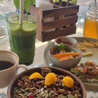 Mango bowl, avocado mushroom toast, gold kombucha, green detox juice and americano. at Urth Organic Cafe & Eatery in Vagator