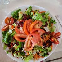 Salad with tomatoes added. at Como En Mi Casa in Puerto Viejo De Talamanca
