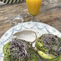 Fresh pressed orange juice and a sourdough bun with avocadOra☀️🥑  at Den Blå Ged in Faarevejle