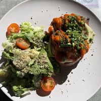 Slice of bread topped with hummus and falafel, with a slide of salad  at Stullenfabrik in Leipzig