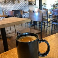 Classic drip coffee with oat milk at Curiouser Coffee and Conservatory in Apple Valley