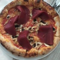 Pizza regina at Swami's Garden in Praia Da Luz