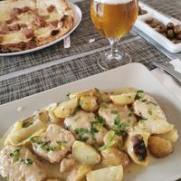 The Scallopine al limone served with potatoes at Swami's Garden in Praia Da Luz