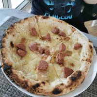 Vegan cheese and sausage pizza at Swami's Garden in Praia Da Luz