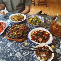 Food spread with veggie and meat dishes. at Xiao Xiong Si Fang Cai - 小熊私房菜（天门山索道店） in Zhangjiajie