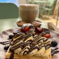 Vegan waffles and latte with homemade almond milk at Kokoro Cafe in Buenos Aires