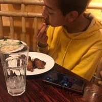 bro eating bbq drumsticks and nova pasta at One Veg World in West Covina