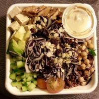 Monster protein salad (to go). Grilled tempeh, marinated tofu cubes, avocado, chick peas, dried cranberries, marinated adzuki beans, red cabbage, cucumber, grape tomatoes & hulled watermelon seeds on lettuce. at Fresh on Eglinton in Toronto