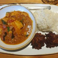 Cauliflower, red pepper & spinach Keralan curry served with steamed basmati rice and onion bhajis at Plough and Flail in Knutsford