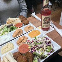 Falafel plate (3 falafel balls, pita bread, salada, 3 dips of your choice and chili tomato sauce on request) at Vegi in Tubingen