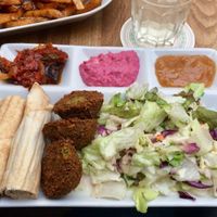 Falafel plate with red beet hummus, mango chutney and eggplant dip. at Vegi in Tubingen