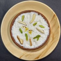 Phirni: a generation passed Indian dessert, slow cooked grounded rice in plantmilk, spices n nuts. Contain: coconutmilk. Glutenfree. ₹80 per portion.  at Vegan Daily  in Kolkata