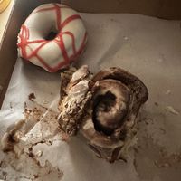 Cream cheese raspberry drizzle and a cinnamon roll  at Level 5 Donuts in Madison