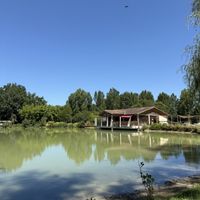 View of the Guinguette from across the lakee  at Belli Guinguette de Salvagnac  in Salvagnac