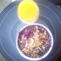 Açai bowl with granola, chocolate chips and coconut and a fresh orange juice at Juice Press - Lower East Side in New York City