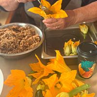 85 year old grandma stuffing zucchinis flowers  at Athos Cafe Deli in Strathmore