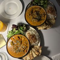 Vegan butter masala (tofu) + okra mustards curry. Both upgraded to have vegan garlic naan.   at Social Llama Cafe in Toronto