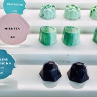 Chocolate display featuring vegan-friendly praline poprocks.   at Janice Wong at the Supertree in Central Singapore