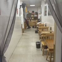 A few bigger tables in the back (half visible)  at Xiaobin Sushi in Chengdu