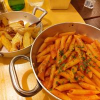 Penne arrabbiata and baked potatoes at La Pasta Taverna in Como