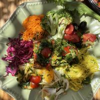 Vegetables on sweet potato, with salad surrounding. Ask for vegan option - without the cream drizzle on top.  at House of Wonders in Cascais
