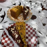 Carrot cake and almond and berry . We shared a slice of each . Delicious   at House of Wonders in Cascais