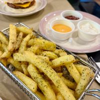 Spiced vegan fries: Belgian fries seasoned with thyme, parsley, paprika, rosemary, served with vegan sauces: aioli, bbq, and smoky sriracha at Baka Vieja Burger Shop in Gijon