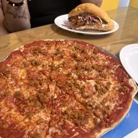 Happy hour pizza with meatballs and torta with Al pastor in back   at Vegatinos  in North Hollywood