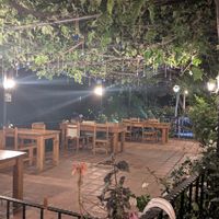 Terrace with evil eye pendants hanging from the ancient vine. at Nihan's Kitchen in Oludeniz