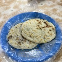 One pupusa with beans and one with squash  at Pupusería Zoila Olocuilta in Olocuilta
