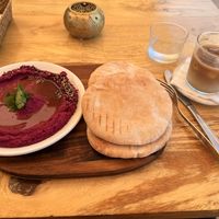 Beetroot Hummus with pita and oat milk flat white  at George's in Mallorca