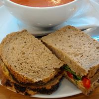 Red pepper soup with harissa, and a houmous and ted pepper sandwich. Tasty. at Meadowlark No. 39 in Edinburgh