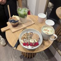 Yoghurt bowl and gingerbread matcha, mini acai bowl in background at ORA Wellness Cafe in Norwich