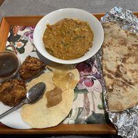 Onion Bhajis, poppadoms, tarka daal, and tandoori roti   at Mughal Kitchen in Lincoln