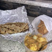 Potato stir fry with cauliflower, vegetable samosa & naan 🫓💌  at Garnish Indian Restaurant in Windhoek